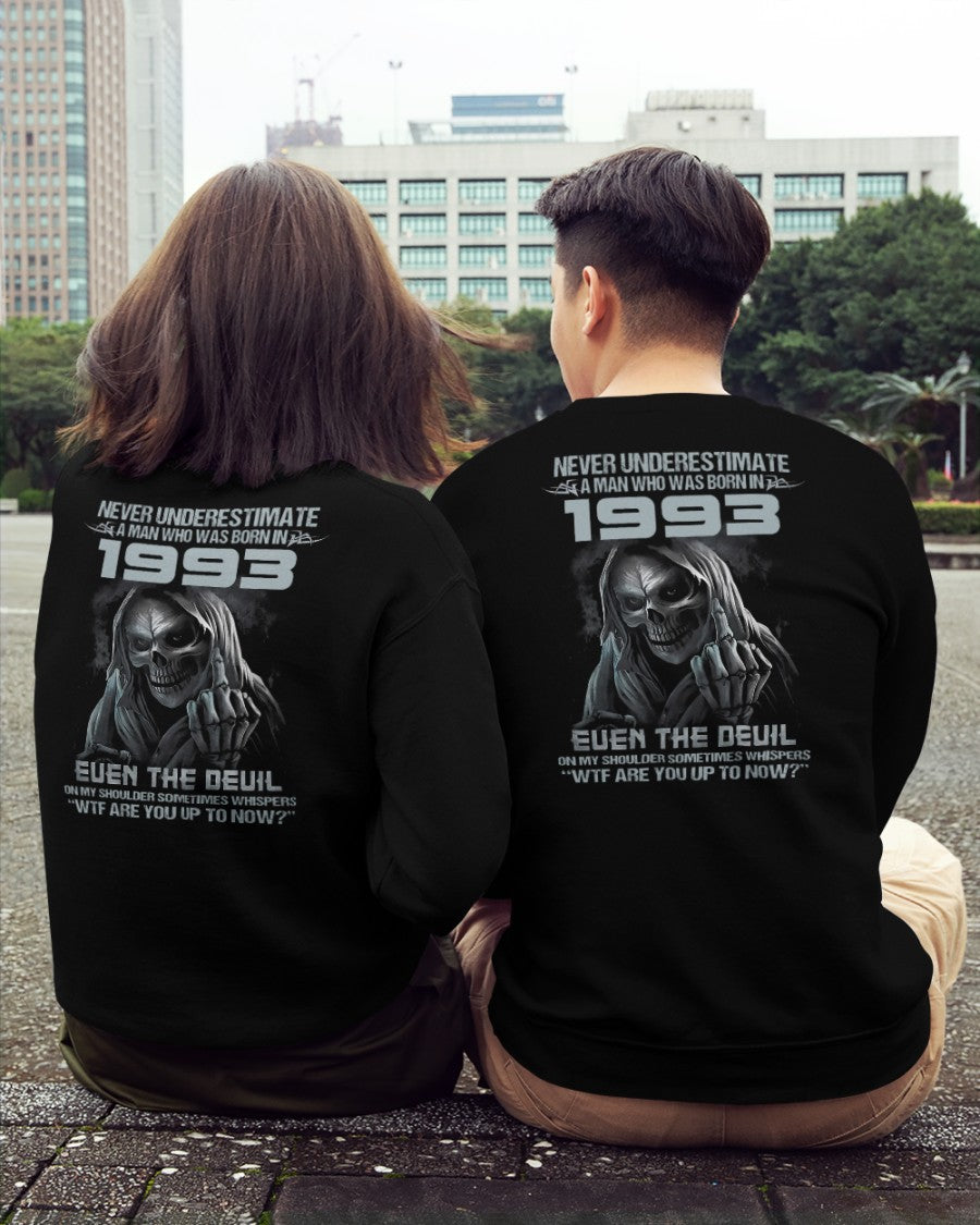 Black TEELUVS.COM T-shirt featuring the bold "Never Underestimate Us 1993" graphic design.