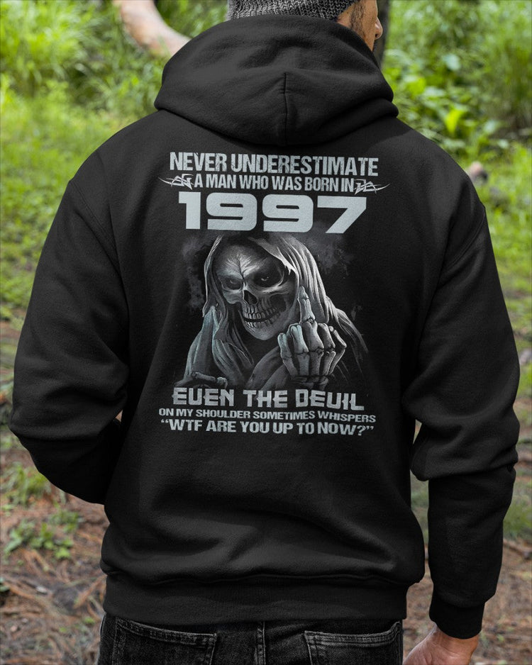 Black TEELUVS.COM T-shirt featuring "Never Underestimate Us 1997" printed graphic, short-sleeve casual crew neck shirt.