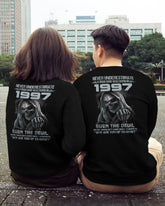 Black T-shirt from TEELUVS.COM with "Never Underestimate Us 1997" printed front, casual fit, soft cotton fabric.