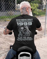Black TEELUVS.COM T-shirt with "Never Underestimate Us 1999" slogan, front view, casual fit, soft cotton fabric.